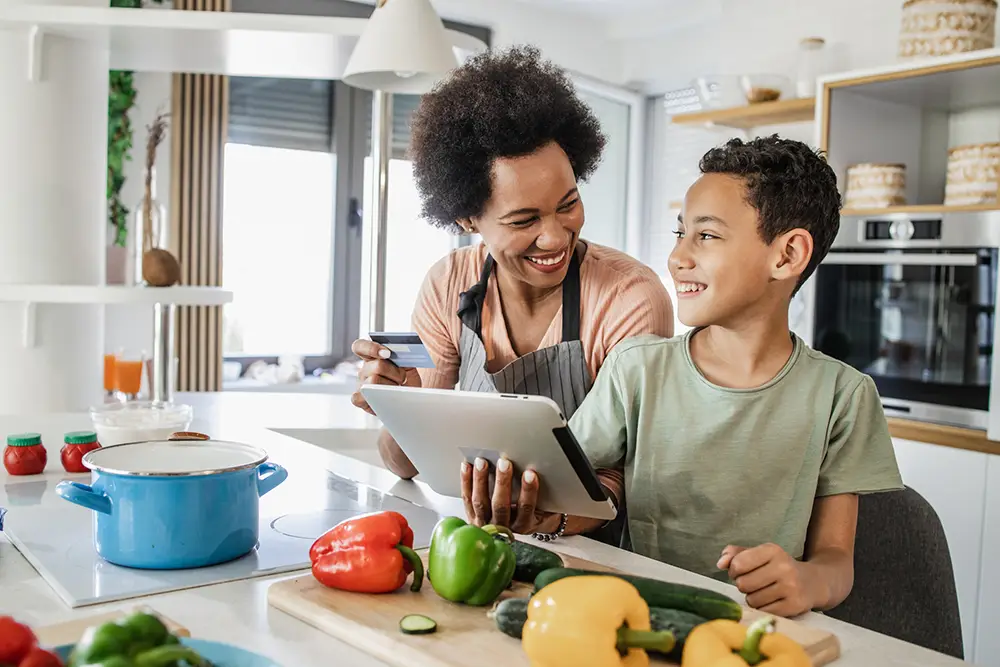 mother-and-son-cooking-ordering-groceries-online